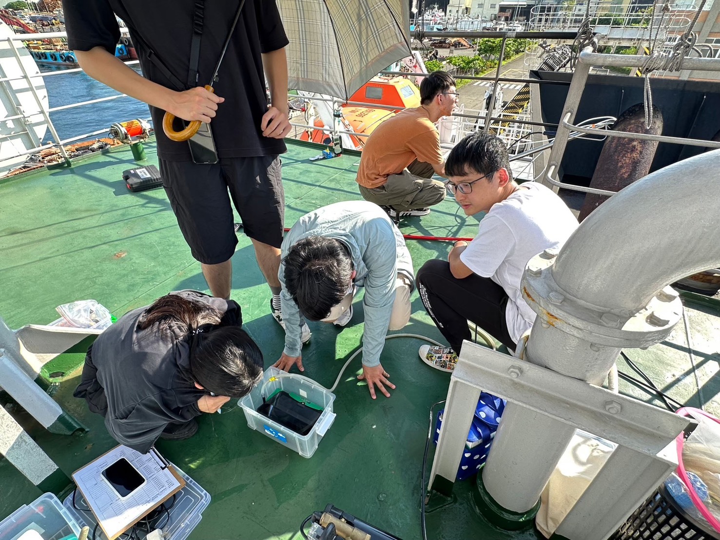 Researchers from the Aerosol Science Research Center and the Institute of Environmental Engineering at NSYSU record measurement data during field monitoring aboard a large workboat in Kaohsiung Port.Image
