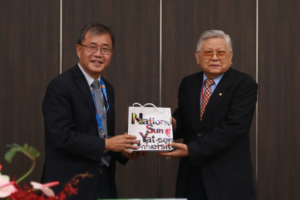 NSYSU President Ying-Yao Cheng (on the left) handed a gift to Fellow of Academia Sinica Professor Chang-Hung Chou (on the right).Image