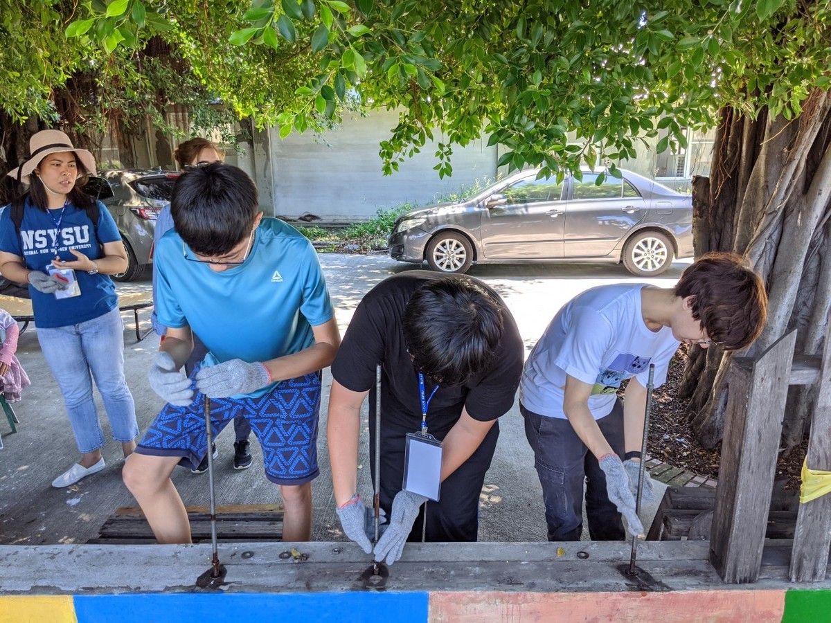 The students repaired a fence in the community.