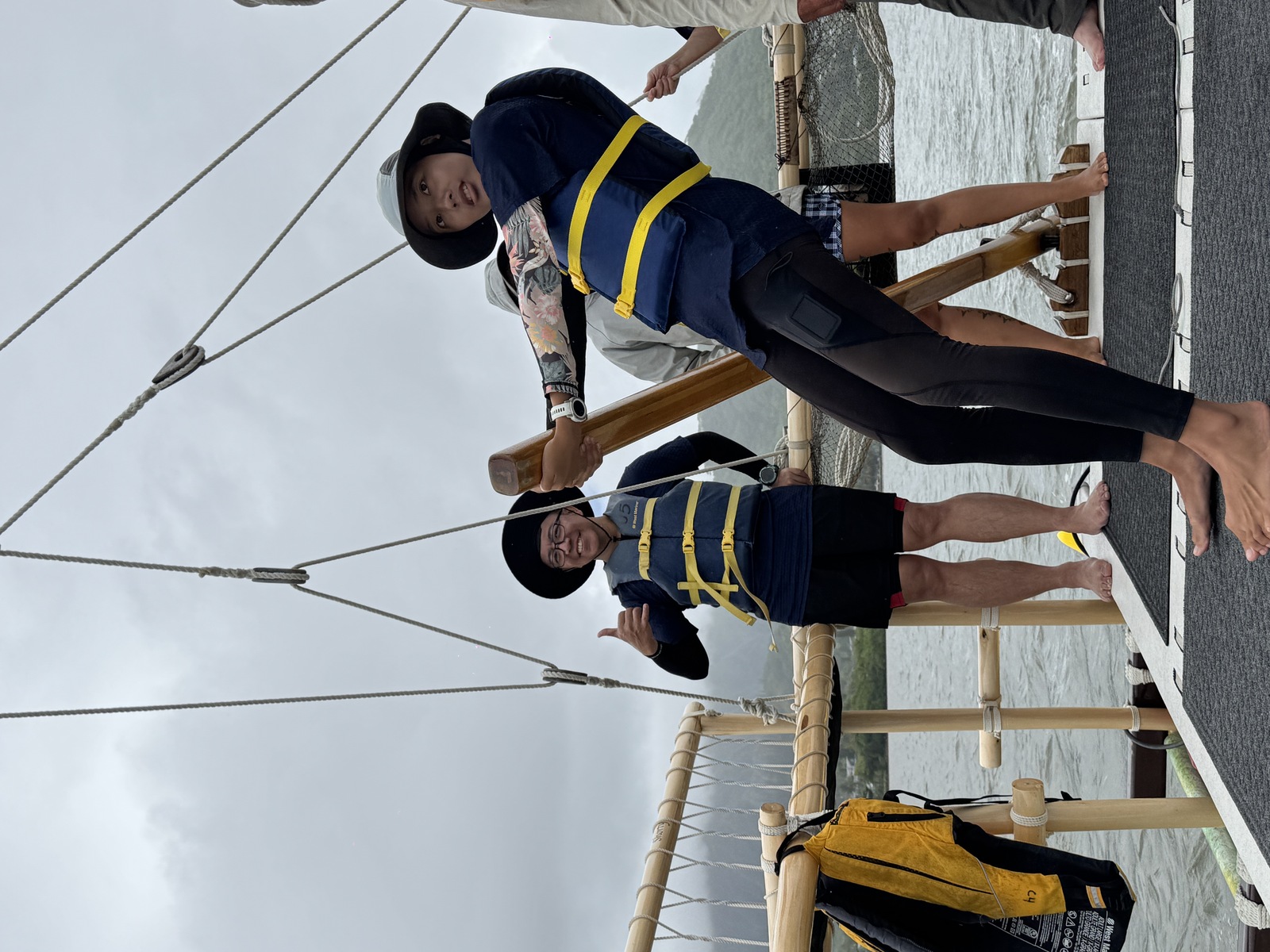 A student works with the hoe uli (steering paddle) aboard the double-hulled voyaging canoe Kānehūnāmoku.Image