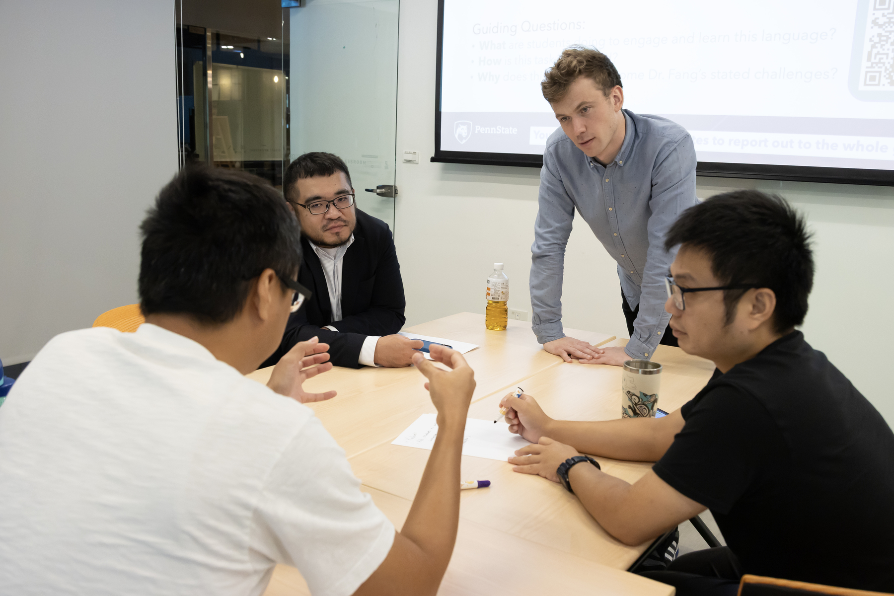 PSU Assistant Professor Jacob Reiker joins group discussions with participants.Image