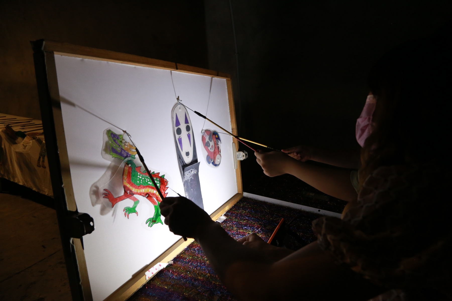 Children experiencing shadow play performance.