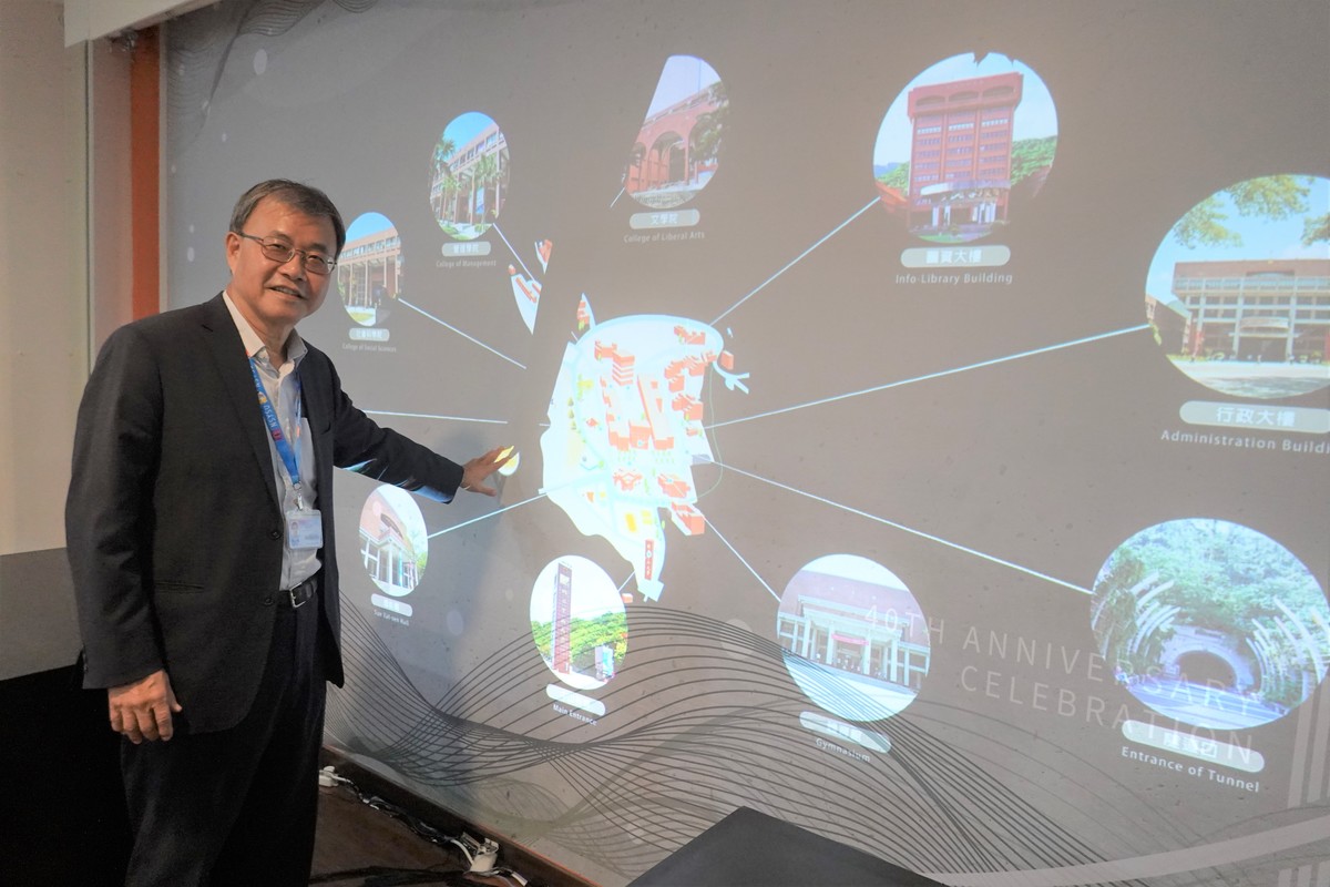 President Ying-Yao Cheng slightly touched the screen for the interactive campus map to be projected.