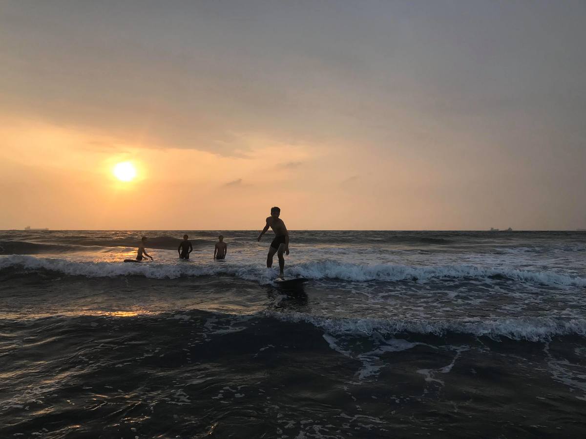 Learn to surf and pay your tuition by collecting trash on the beachImage