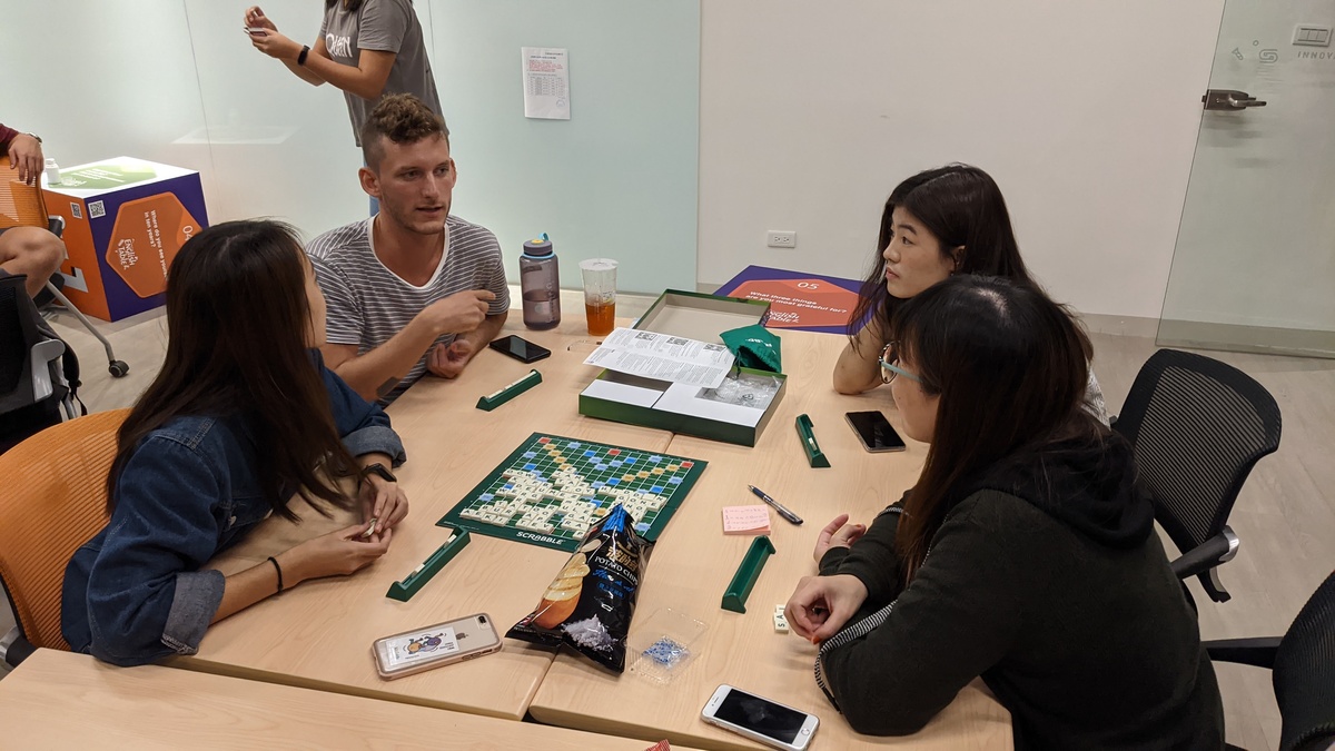 Students playing board games in English