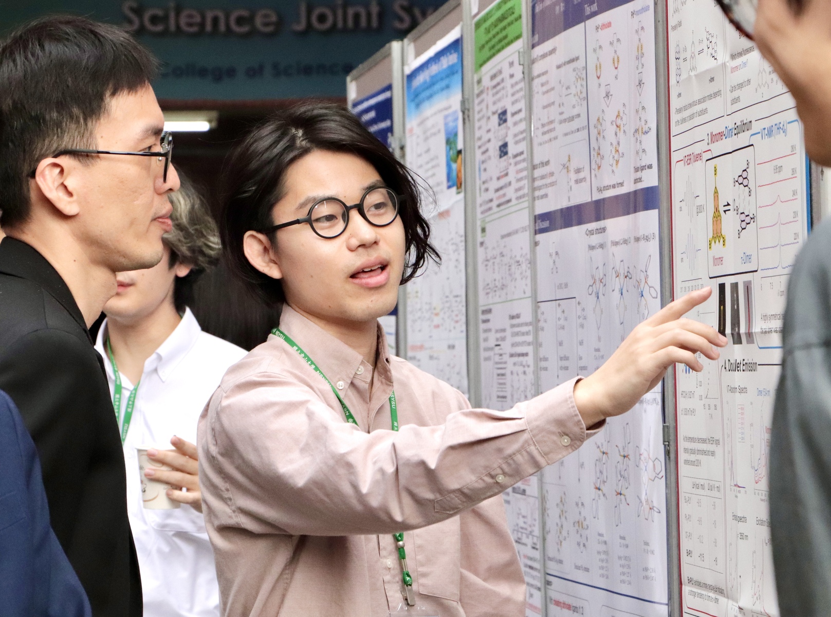 Students from the University of Osaka present their research findings during the poster session.Image