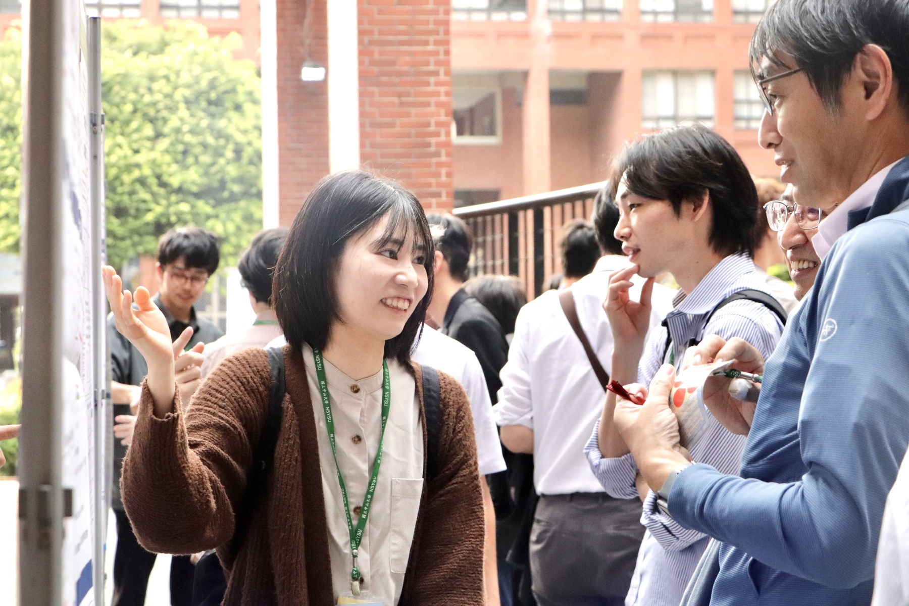 Students from the University of Osaka present their research findings during the poster session.Image