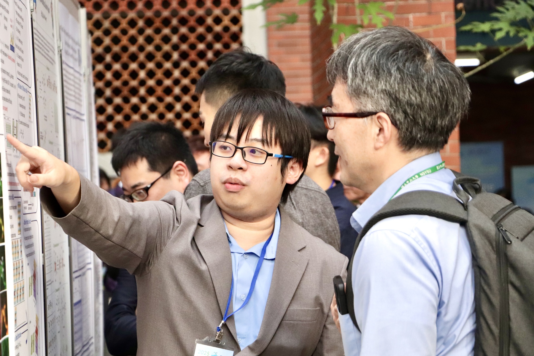 Students from NSYSU present their research findings during the poster session.Image