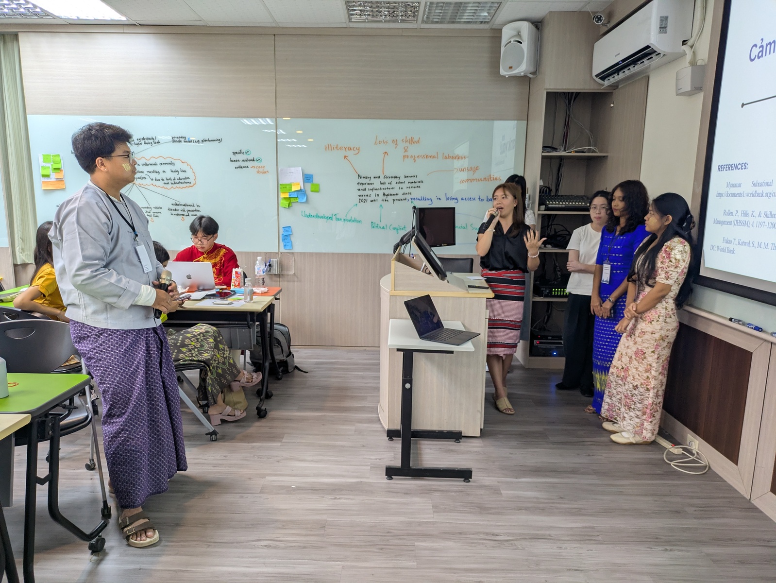 Participants deliver their final action plan presentations.Image