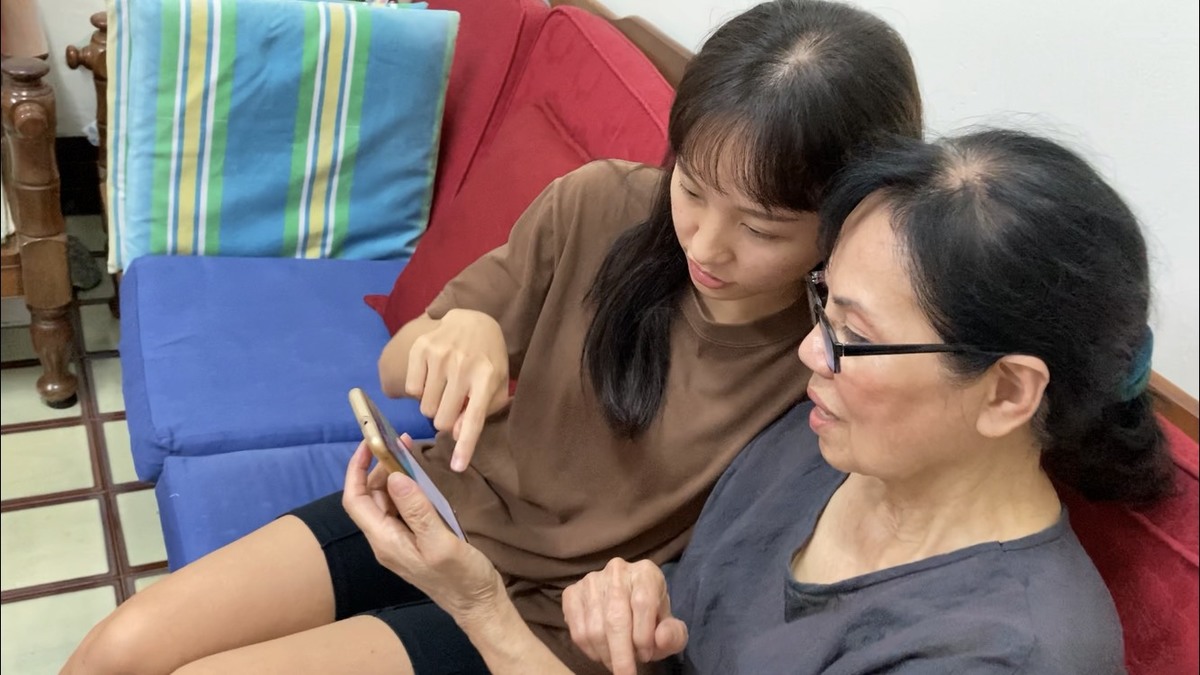 A student’s grandma learns to edit photos on her smartphone.Image