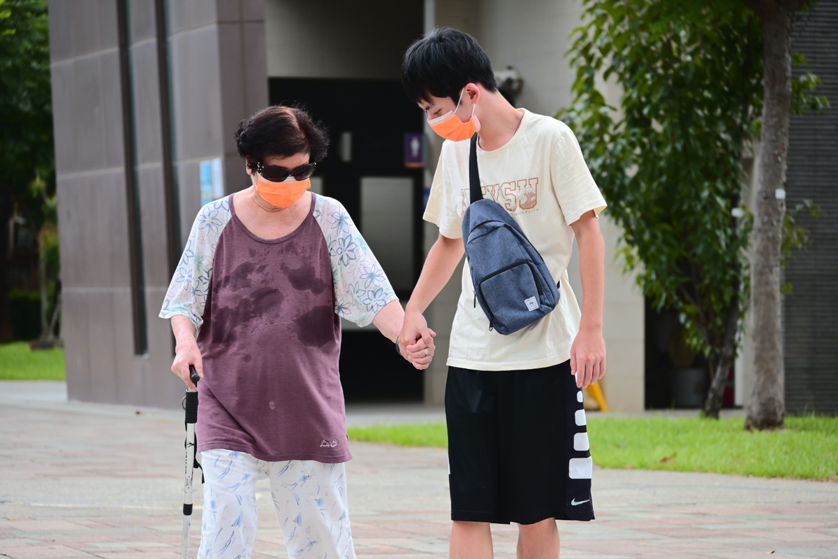 As student walking with his grandma.