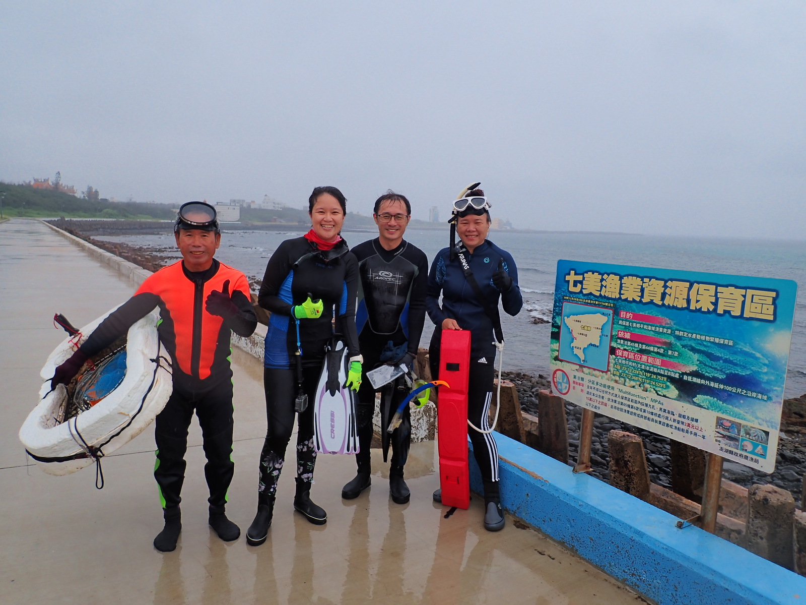 Professor Yi Chang (2nd from right) poses with resident volunteers and doctoral students.Image