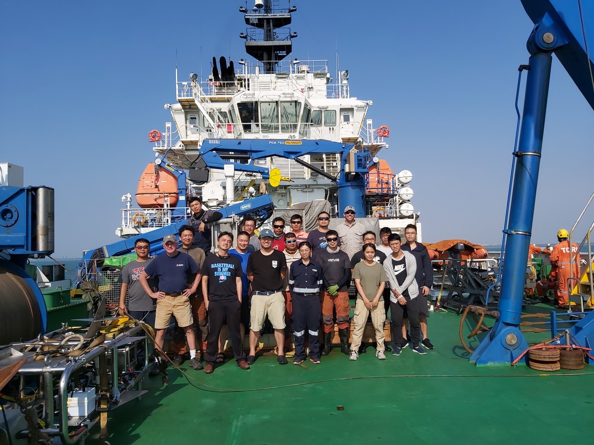 The researchers of WHOI and NSYSU with the crew and technical team on the board of R/V Legend after the expedition. From the left in the front row is WHOI engineer John Kemp, Associate Professor Linus Yung-Sheng Chiu of the Institute of Undersea Technology at NSYSU (second from the left), WHOI scientist Ying-Tsong Lin (third from the left), captain of R/V Legend captain Chiu-Hsing Huang (in the center), and WHOI research engineer Peter Koski (first from the right in the back row). / photo provided by Associate Professor Linus Yung-Sheng Chiu