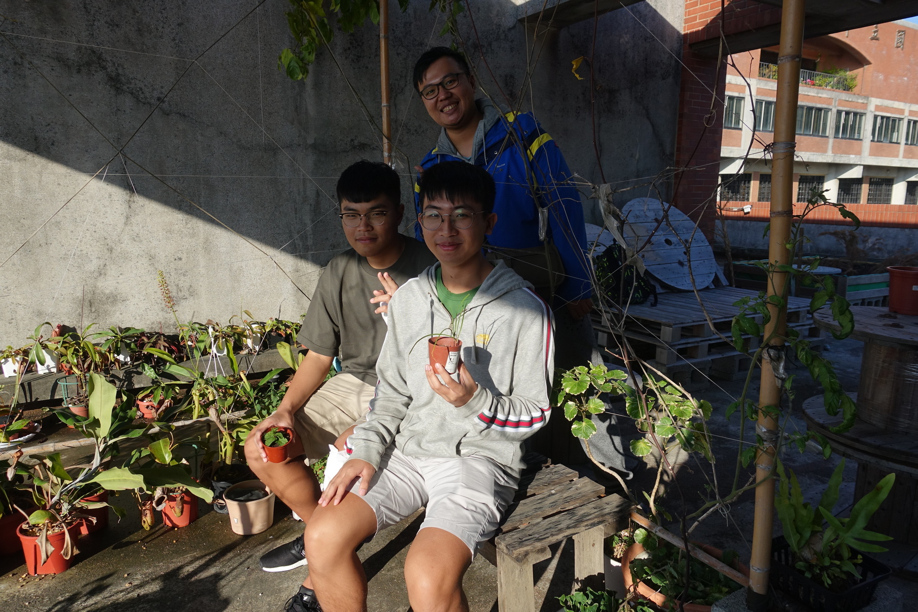 The garden has a shady place with a DIY pallet table and chairs for the students to take a rest.Image