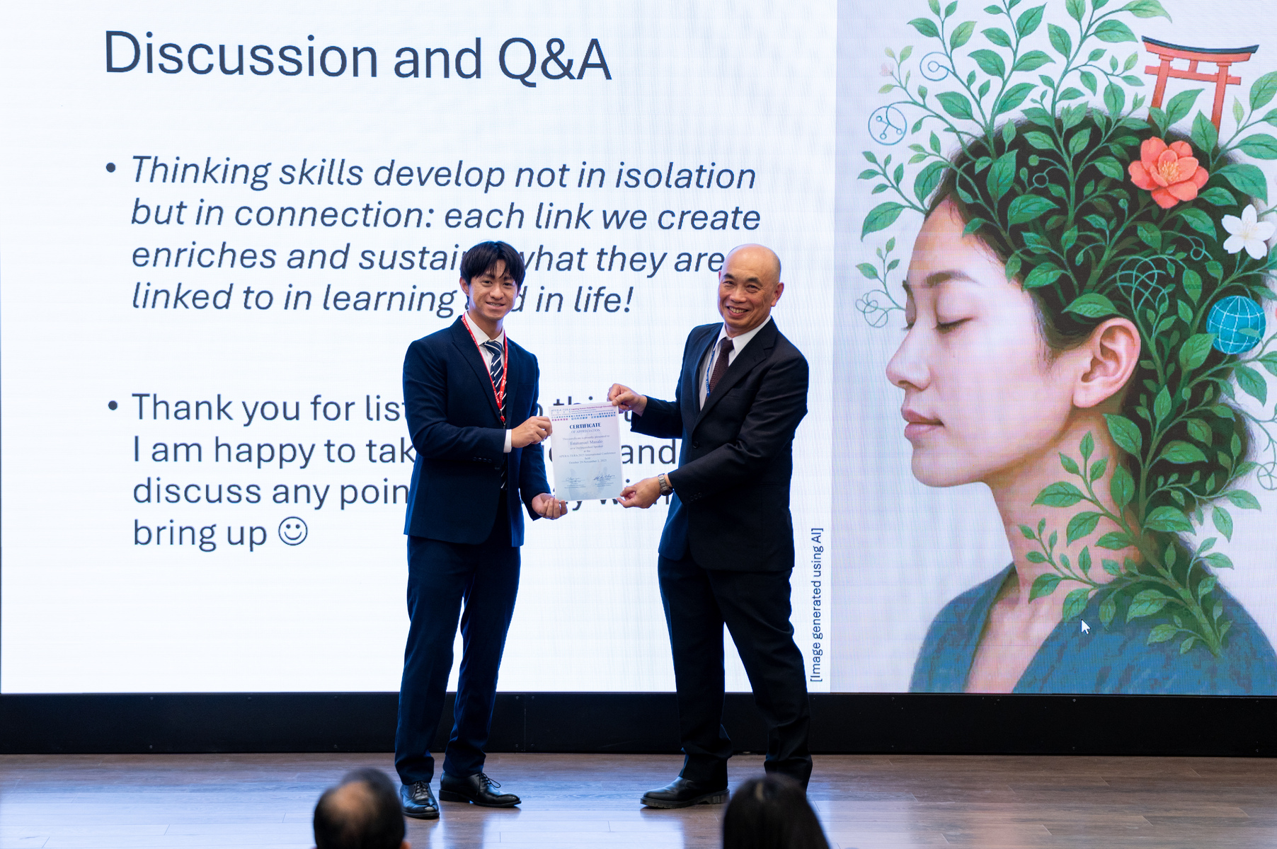 Presentation of a certificate of appreciation to Professor Emmanuel Manalo (right).Image