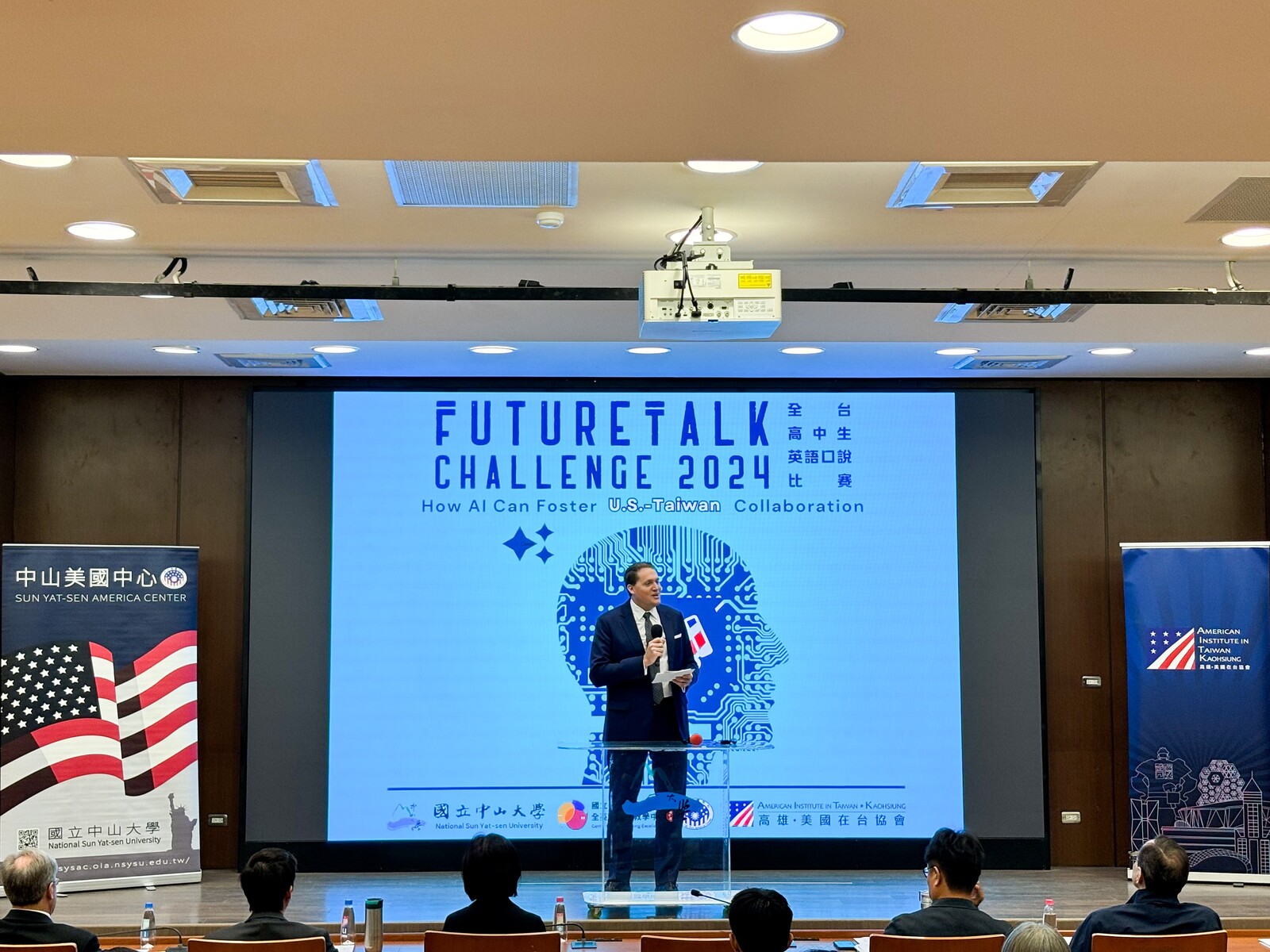 Neil Gibson, Director of AIT Kaohsiung, delivered the opening remarks at the 2024 Future Talk Challenge co-hosted by NSYSU and AIT.