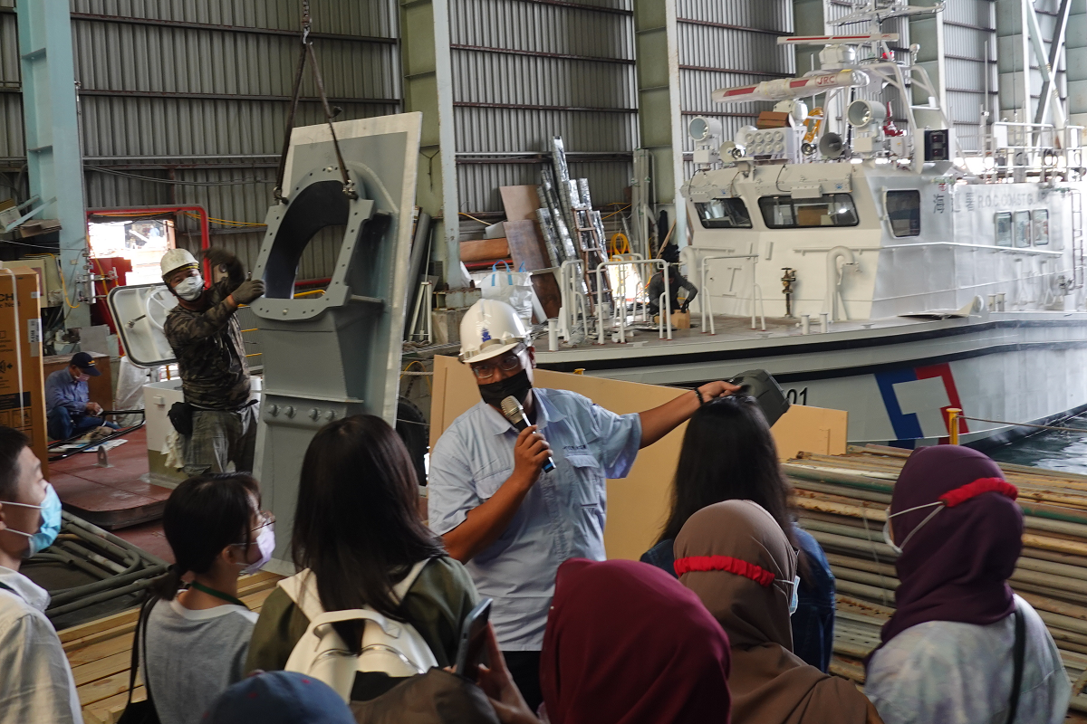 The employee of JSSC explaining the work in progress in the shipyard.